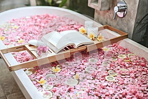 Bath tub with flowers and lemon slices photo