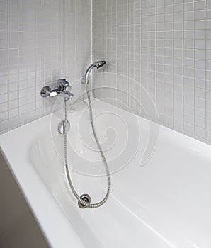 Bath tub with shower attachment photo