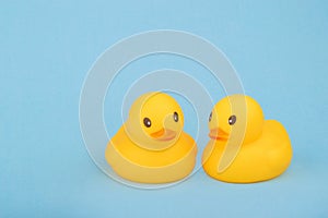 Bath yellow rubber ducks on blue background