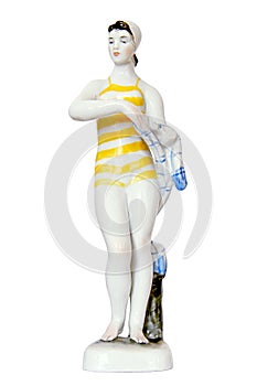 Bather Figurine isolated on white. The statuette is made in the USSR. Beautiful woman in a bathing cap and yellow striped bathing