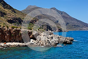 Bathers and hikers in the Cala della Disa Natural Reserve of the Zingaro, Sicily photo