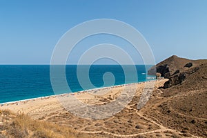 Bathers sunbathing on Los Muertos beach, Carboneras, Almeria, Spain.