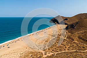 Bathers sunbathing on Los Muertos beach, Carboneras, Almeria, Spain.