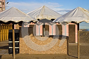 A bathhouse with white sun umbrellas on the beach of the Mediterranean Sea Italy, Europe