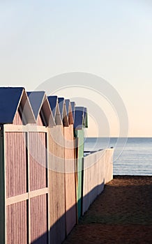 Bathing boxes and fence at sunset, empty