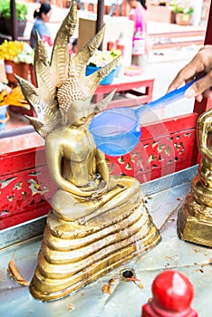 Bathing the Buddha images in Thailand`s Songkran Festival.