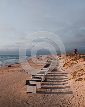 The bathing huts at Blokhus Beach, Denmark during sunset.