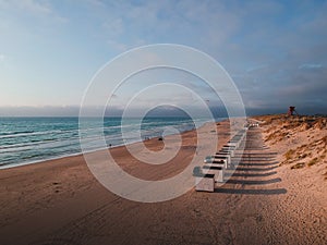 The bathing huts at Blokhus Beach, Denmark during sunset.