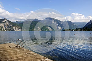 Bathing place with beautiful panorama of Traunsee lake with Traunkirchen town in background. Salzkammergut, Austria.