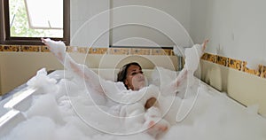 Bathing Young Woman Relaxing In Bath Full Of Foam, Smiling Beautiful Girl Enjoys Spa At Home