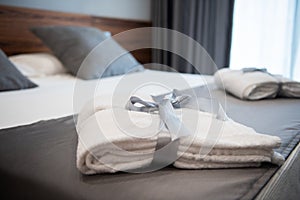Bathrobe on bed in hotel room