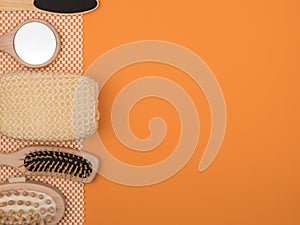 The bathroom accessories from ecological materials on orange background.