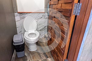Bathroom with beautiful toilet and wood door