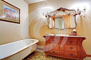 Bathroom with claw foot tub and antique vanity