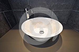 Bathroom detail with round marble wash basin