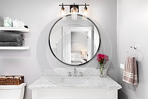 A bathroom detail with a view towards the bedroom in the mirror.