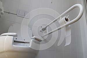 Bathroom equipped with toilet for the elderly and disabled people with fall prevention handle