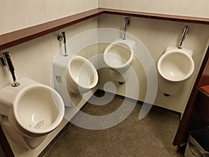 Bathroom with four urinals on wall together