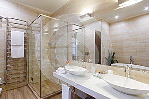 Bathroom of the hotel rooms, with a shower and a few washbasins