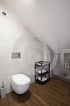 Bathroom with inclined wall