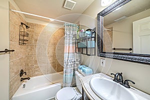 Bathroom interior with antique fixtures and ceramic tile walls