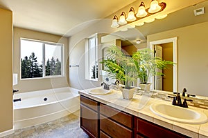 Bathroom interior with beige walls and tile flooring.
