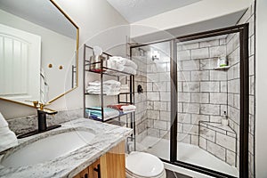 Bathroom interior with black and white tile wall and marble countertop