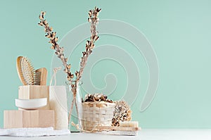 Bathroom interior in green mint menthe with beige wooden organic cosmetic accessories -  bath sponge, soap, towel, dried flowers.