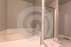 Bathroom interior of a new home with built in bathtub and separate shower stall