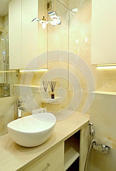 Bathroom interior with overhead washbasin and decorative lighting