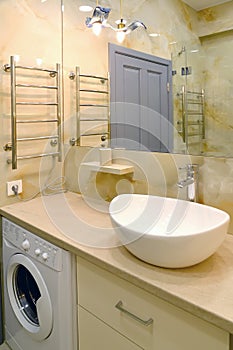 Bathroom interior with overhead washbasin and washing machine