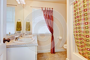 Bathroom interior with two sinks and big mirror. Also red curtain.