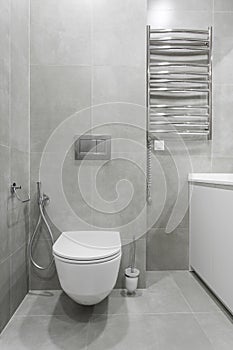 Bathroom interior with white toilet and bidet