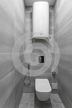 bathroom interior with white toilet and bidet