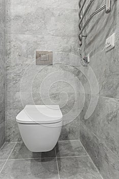 bathroom interior with white toilet and bidet