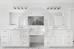 A bathroom with a large white cabinet and a grey tiled walk-in shower.