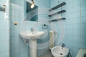 Bathroom with mirror, porcelain sink with foot of the same material,