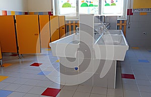 Bathroom of the nursery school with ceramic sinks