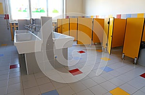 Bathroom of the nursery school with white ceramic sinks