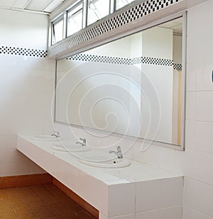 Bathroom at office.Handbasin and mirror in toilet photo