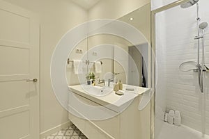 Bathroom with one-piece white porcelain sink, large frameless wall mirror