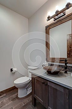 Bathroom powder room interior details with round copper sink and dark faucet