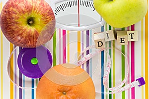 Bathroom scale with fruits and diet text