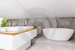 Bathroom with shaped bathtub