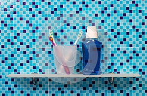 Bathroom. Shelf with glass, toothbrush, and mouthwash