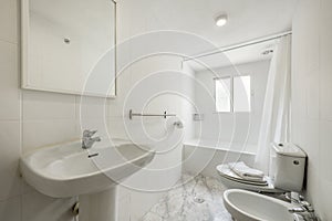 Bathroom with shower cabin with curtain, white sink under mirror