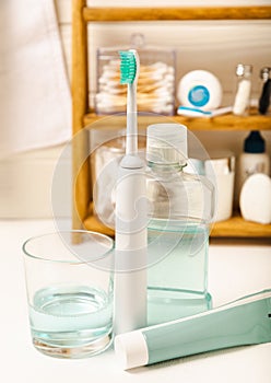 Bathroom with sonic electric toothbrush, toothpaste, mouthwash, dental floss and tongue cleaner