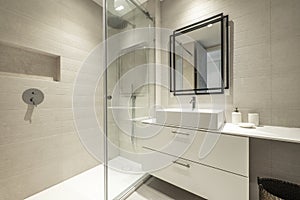 Bathroom with square mirror with black metal frame, white porcelain