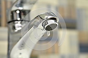 Bathroom tap leaking water drops