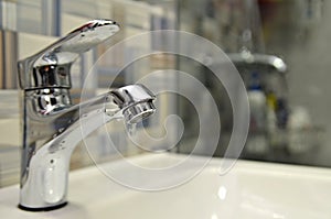 Bathroom tap leaking water drops